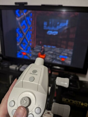 I wanted to get the screen in focus as it shows the recent Dreamcast port of Doom64, but the camera focused on the fishing controller in my hand in the foreground