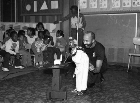 A man operates a puppet for school children at Little Hearts Pre School, Los Angeles, CA (1984) Photo by Guy Crowder