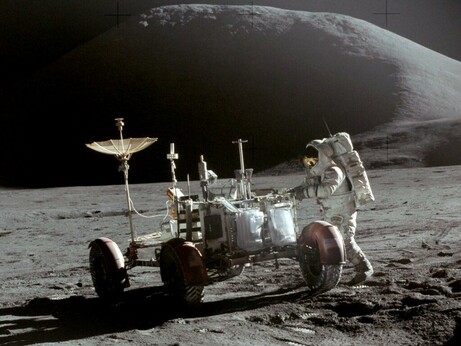 Lunar Module Pilot Jim Irwin is seen with the Lunar Roving Vehicle, with Mount Hadley in the background.  Taken by Commander David Scott on 31 July 1971.